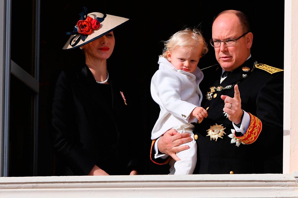 Princess Charlene of Monaco and Prince Albert II of Monaco greet the crowd from the palace's balcony with Prince Jacques of Monaco during the Monaco National Day Celebrations on November 19, 2016 in Monaco, Monaco.  (Photo by Pascal Le Segretain/Getty Images)