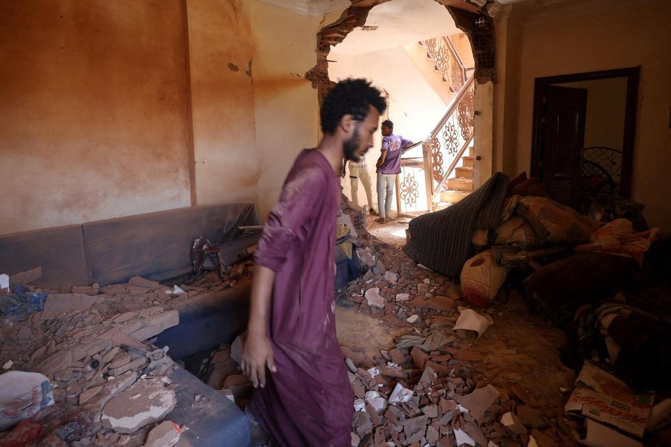 A man looks at the damage inside a house during clashes between the paramilitary Rapid Support Forces and the army in Khartoum. Photo: Reuters