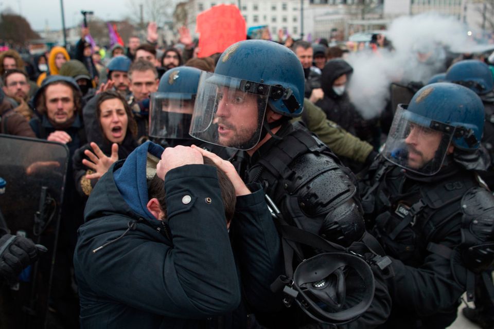 Street battle: Riot police and protesters clash in the city of Nantes yesterday during nationwide strikes. Photo:  Getty Images