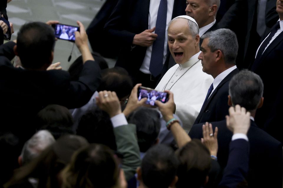 Pope Leo XIV is surrounded by journalists as he arrives at Paul VI Audience Hall in the Vatican to speak to thousands of media workers. Photo: Getty