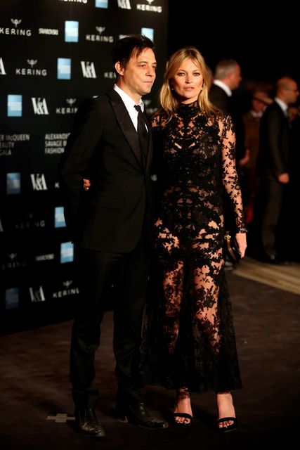Model Kate Moss, right, and her husband Jamie Hince pose for photographers upon arrival at the Alexander McQueen Savage Beauty Gala exhibition