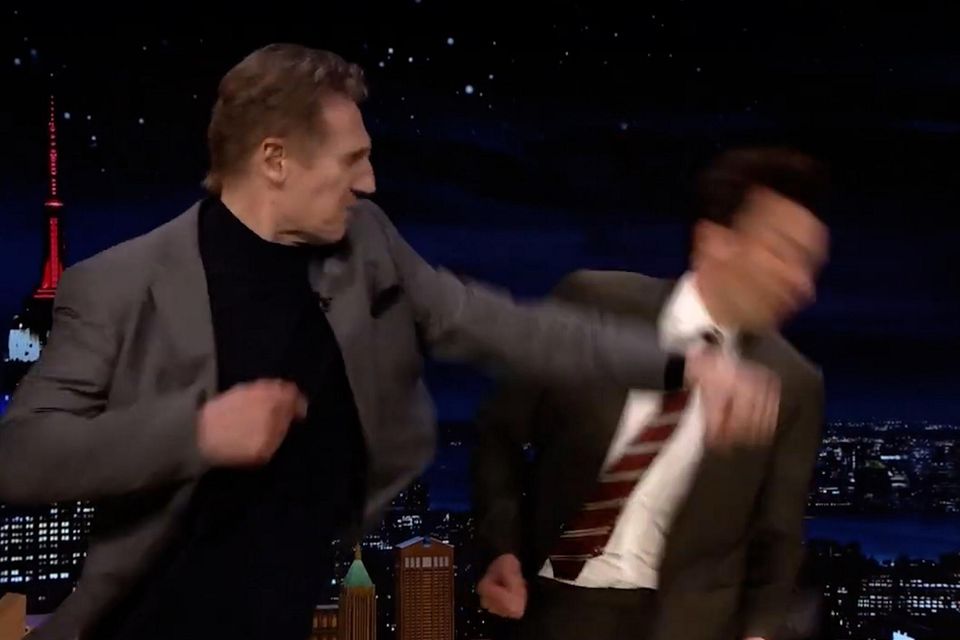 Liam Neeson demonstrating how to do a fake punch on TV host Jimmy Fallon