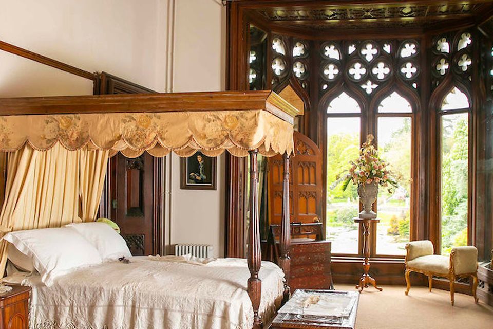 Lady FitzGerald’s bedroom with four poster and a Turkish rug bought at auction
