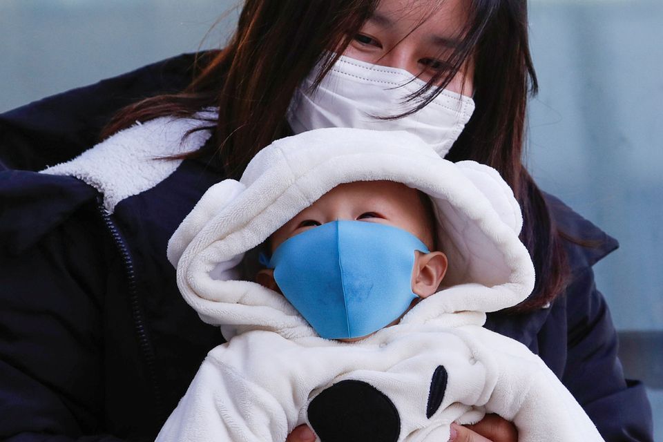 Taking precautions: A mother and her baby wear protective masks in Sapporo, Japan.
Photo: Reuters