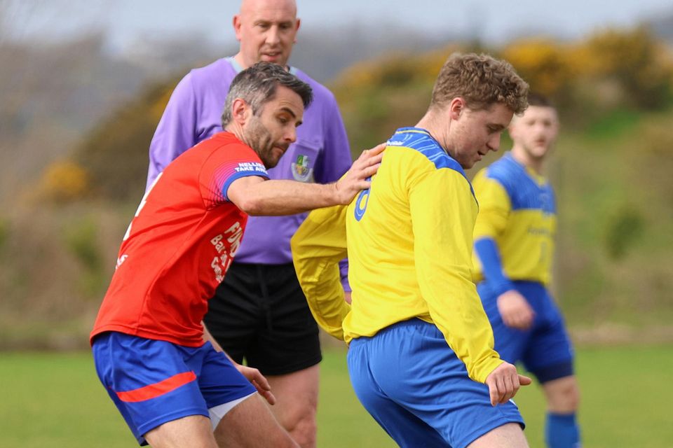 Paddy Doyle of Curracloe United puts pressure on Campile's Eoin Aylward.
