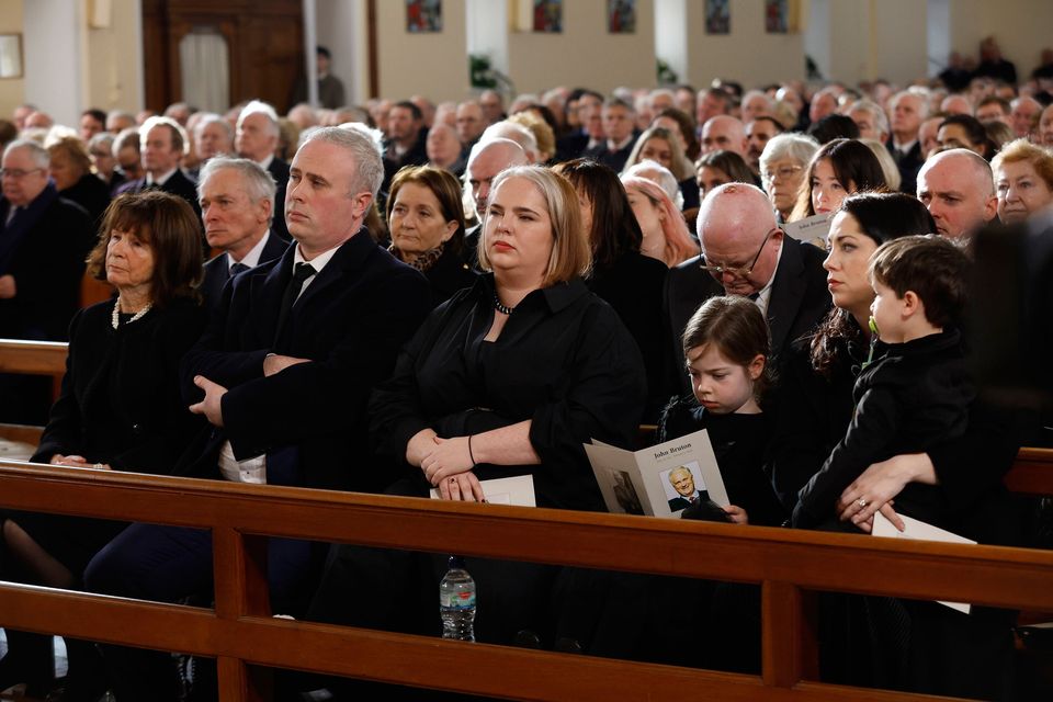 John Bruton's wife Finola, son Matthew (to her left) and brother Richard (behind Mrs Bruton) and extended family members attend the state funeral of the former taoiseach at St Peter and Paul's Church, in Dunboyne, Co Meath Photo: Julien Behal/via Reuters