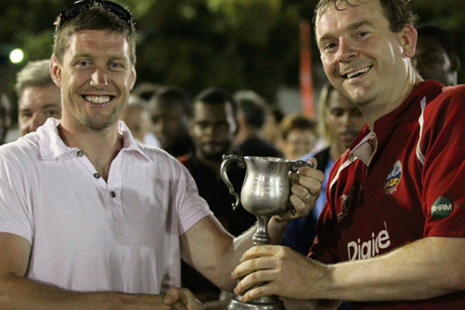 Ronan O'Gara hands the Noss Norgrove Cup to Barbarians captain Johnny Bailey in the British Virgin Islands