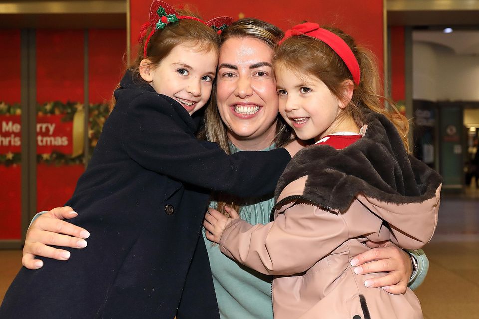 Sisters Molly [7] and Hannah [5] Boles from Dunderry, Co Meath, hug their aunt Jane Martyn at Dublin Airport after she returned home from Sydney for Christmas. Picture: Frank McGrath