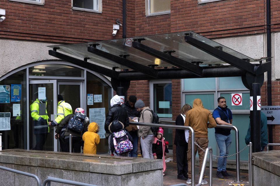 Asylum seekers queue outside the International Protection Office (IPO) Photo: Reuters/Clodagh Kilcoyne