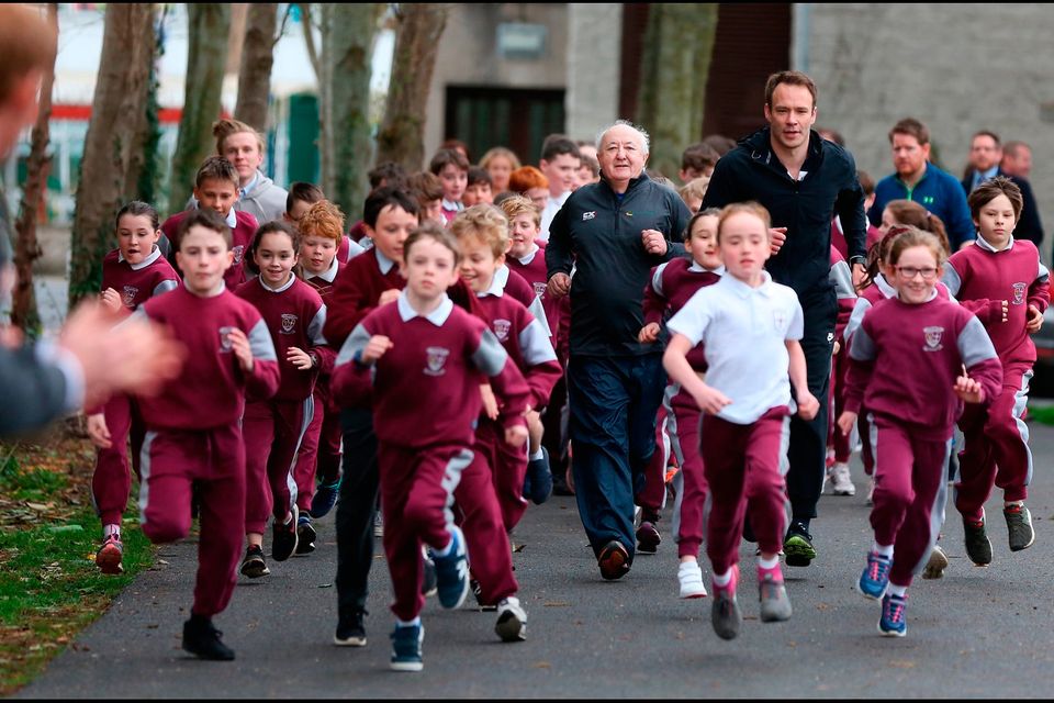 Frank Greally, Athletics Ireland’s ambassador for the Daily Mile, and teacher Patrick Lowery, with children from St Brigid’s National School, Castleknock, last week. Photo: David Conachyof