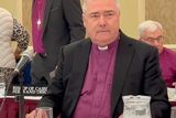 thumbnail: Archbishop John McDowell is challenged by members of the Burke family today.