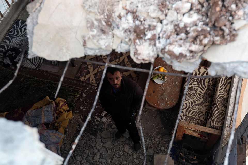 A man looks up inside a damaged house following Israeli air strikes in Al Qulaylah, southern Lebanon. Photo: Reuters