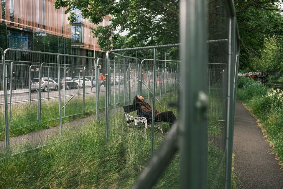 Fenced: A woman spends time on the Grand Canal in Dublin. Photo: Mark Condren