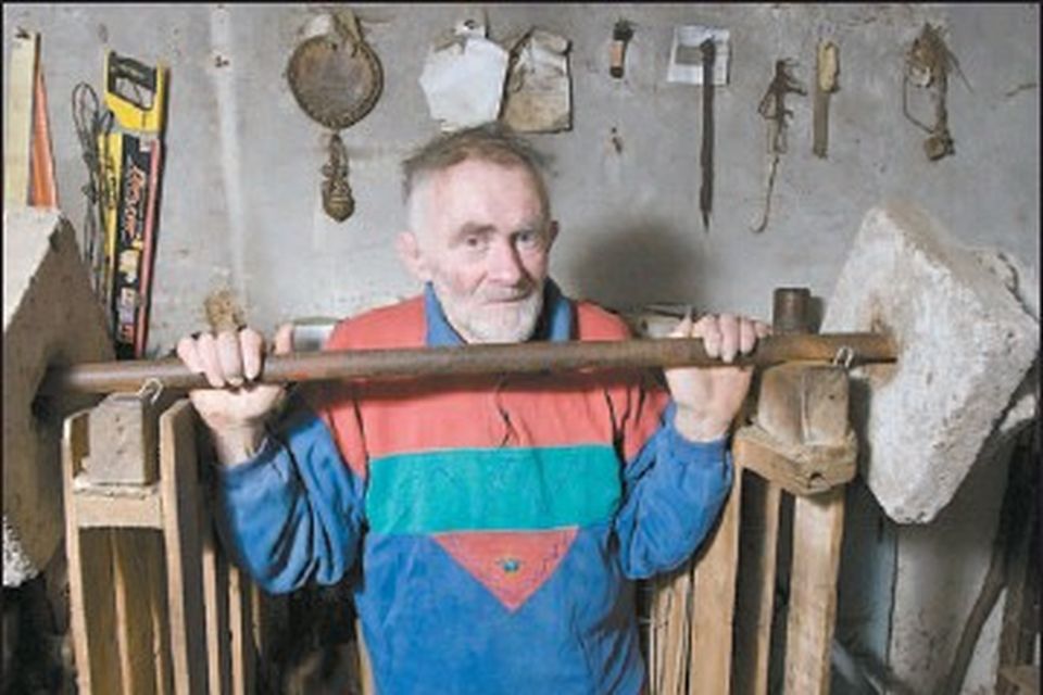 Kerry's Iron Man, Mick Murphy, working out at his home in Cahersiveen with makeshift barbells.