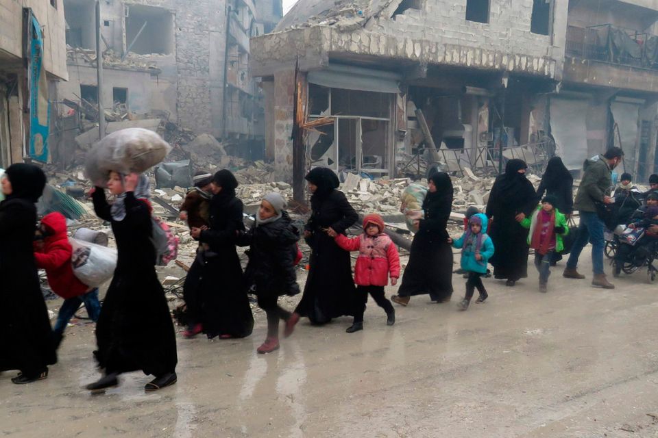 Syrian residents, fleeing violence in the restive Bustan al-Qasr neighbourhood, arrive in Aleppo’s Fardos neighbourhood yesterday, after regime troops retook the area from rebel fighters (Photo: AFP/Getty)