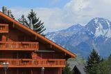 thumbnail: Swiss chalet and Alps mountains in summer at Crans-Montana, Switzerland