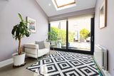 thumbnail: The sun room overlooking the garden and patio