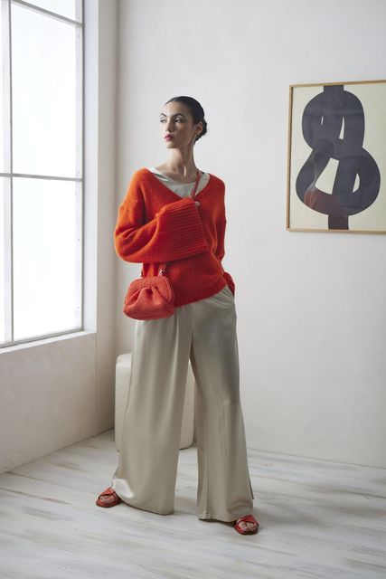 By Malene Birger 'Cimone' orange sweater, €300; 'Pilavis' satin top, €250, ecrustudios.com