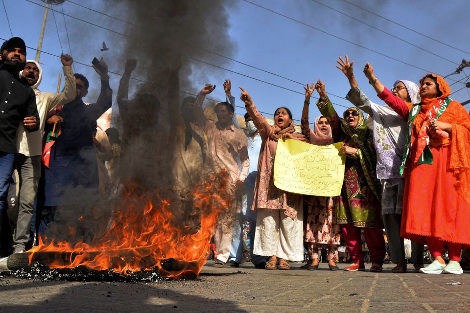 Supporters of Pakistan's former Prime Minister Imran Khan chant slogans next to burning tires during a protest to condemn the arrest of their leader, in Hyderabad. Photo: Pervez Masih/AP