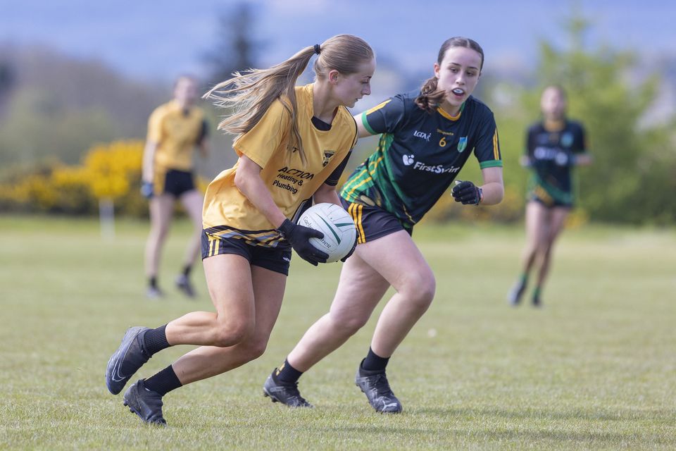 Ashford's Aibhinn Doyle is watched by Clan na Gael's Millie Free. 