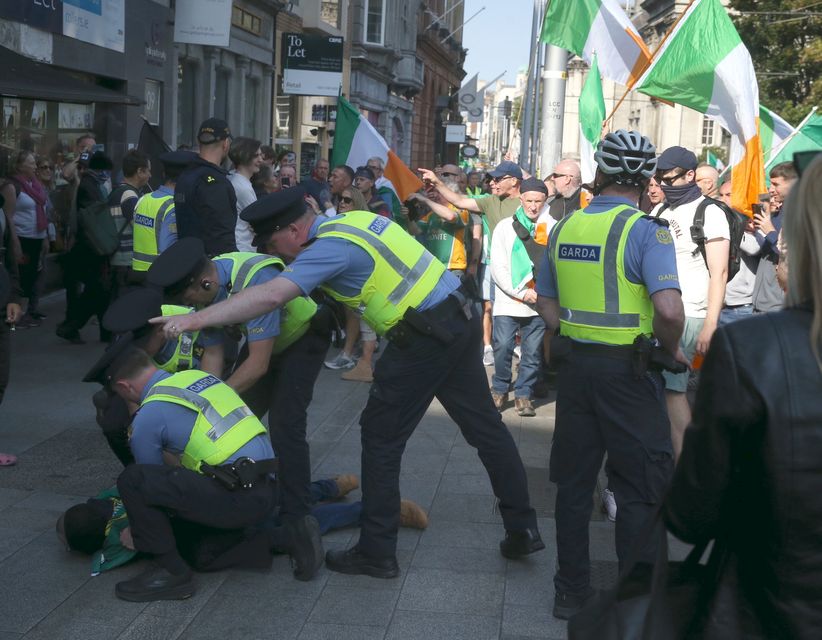 Gardaí arrest 19 people after anti-immigration protesters block O’Connell Bridge with delays for commuters