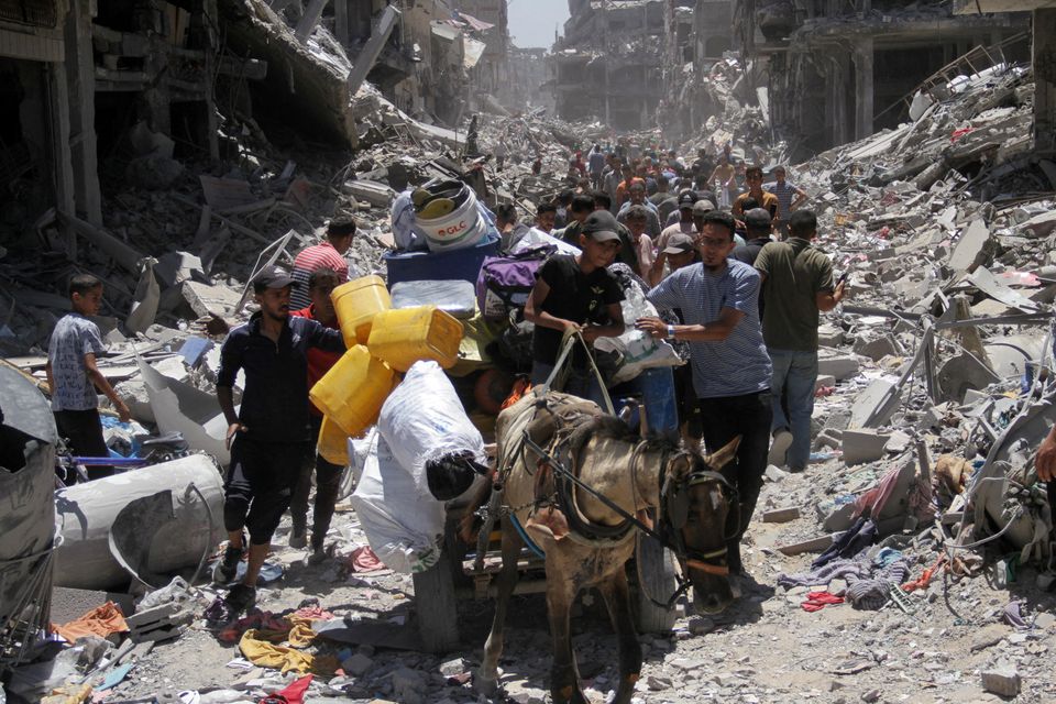 Palestinians make their way, as they inspect the damage after Israeli forces withdrew from Jabalia refugee camp, following a raid, in the northern Gaza Strip, May 31, 2024. REUTERS/Mahmoud Issa
