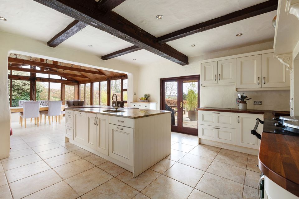 The exposed ceiling beams in the open-plan kitchen