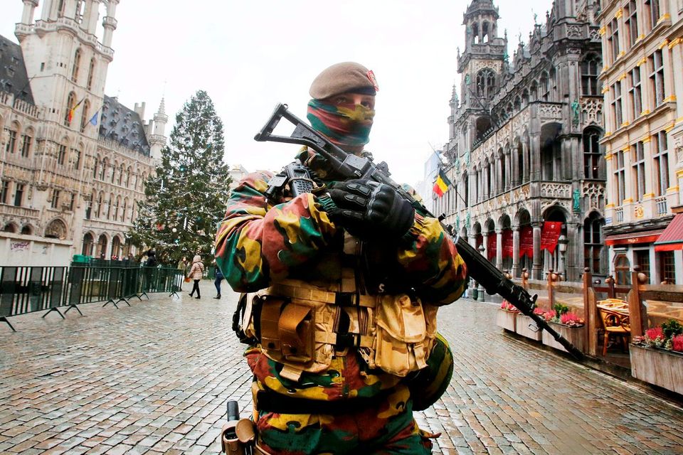 A Belgian police officer patrols the Grand Place in central Brussels yesterday. Photo: AP