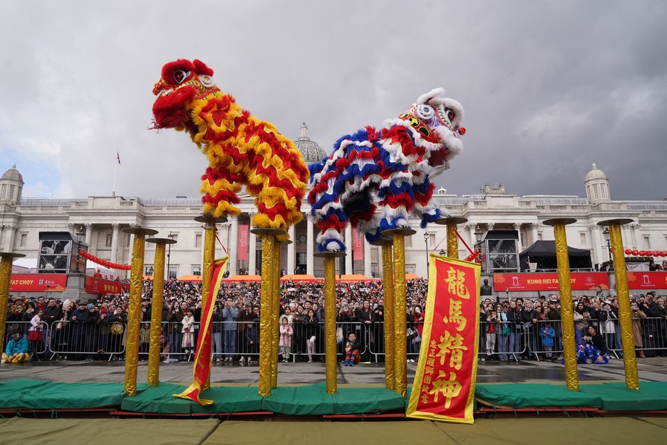 Performers take part in celebrations involving costumes, lion dances and floats in London’s Trafalgar Square (Lucy North/PA)