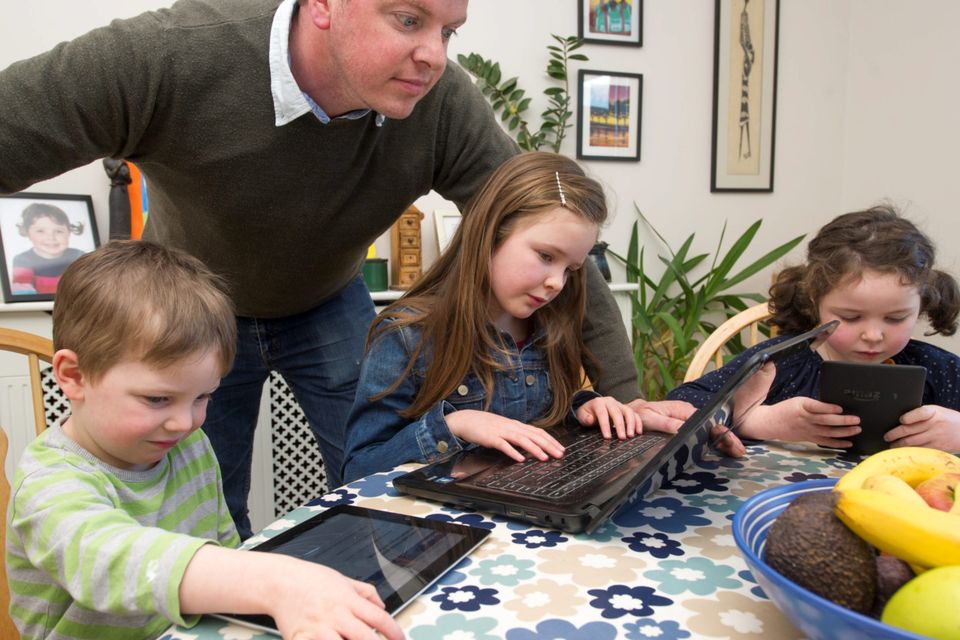 Graham Clifford monitoring his children's internet access, Aodhain (3), Aoife (6) and Molly (8)