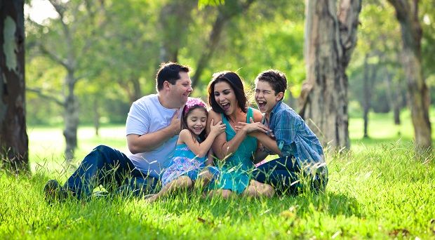 Family laughing during picnic in the park