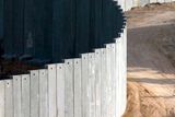 thumbnail: THE WALL: A Palestinian boy cycles near the infamous barrier