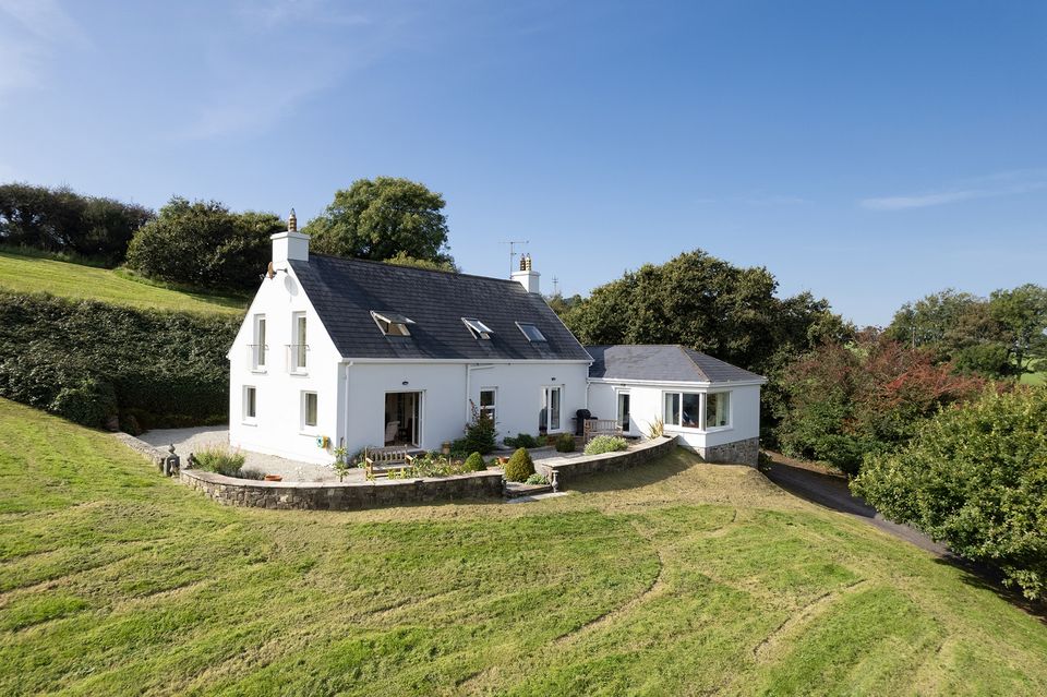 The house sits on the side of a hill