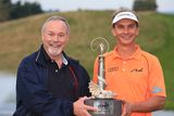 thumbnail: Netherland's Joost Luiten holds the trophy after winning The ISPS Handa Welsh Open with owner of Celtic Manor golf Club, Sir Terry Matthews (left) during day four of the 2014 ISPS Handa Welsh Open at Celtic Manor, Newport.