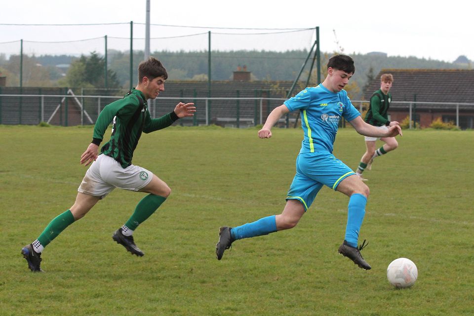 Conor Cullen of North End United is chased by Tom Cashe (Shamrock Rovers).