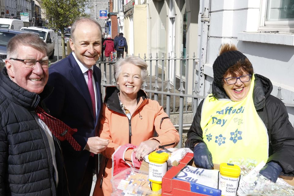 Cllr Ian Doyle, Miceal Martin with daffodil sellers Maura Doyle and Marie O'Brien at the AIB, Main Street, Charleville last Friday.