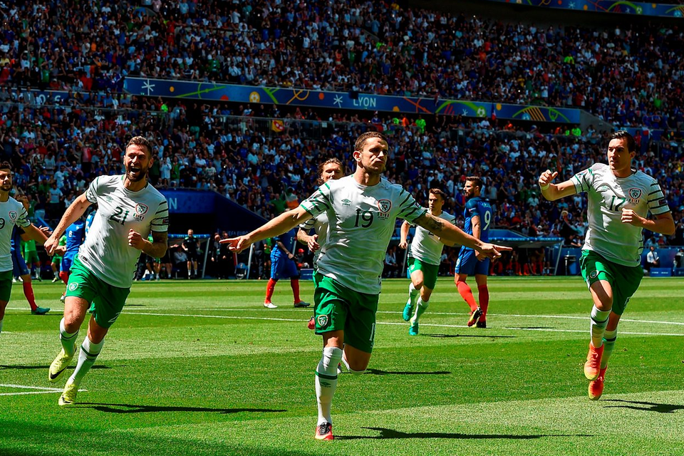 Robbie Brady (centre) celebrates with Ireland teammates after scoring the opening goal from the penalty spot against France yesterday. Photo: David Maher/Sportsfile