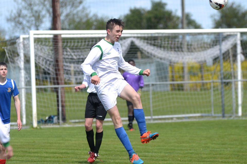 19/05/15. Daniel Emerson gets the ball away during the Under 15s soccer final between Colaiste Phadraig CBS and Templeouge College at Peamount Utd.
Pic: Justin Farrelly.