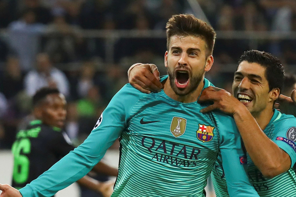 Gerard Pique is joined by Barcelona team-mate Luis Suarez after scoring the winner against Borussia Monchengladbach. Picture: Reuters