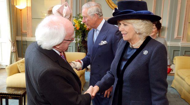 President Higgins shakes hands with the Duchess of Cornwall at the Irish Embassy in London