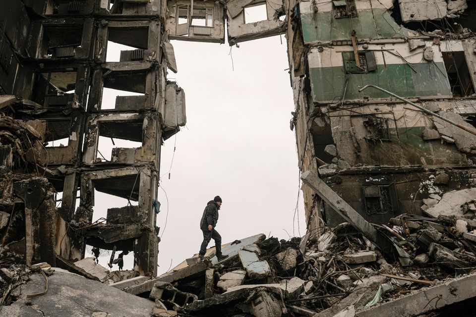 A resident looks for belongings in an apartment building destroyed during fighting between Ukrainian and Russian forces in Borodyanka, Ukraine, Tuesday, April 5, 2022. (AP Photo/Vadim Ghirda)