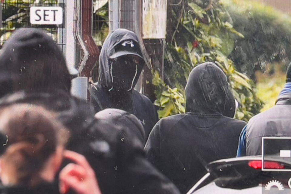 Masked men in Newtownards. Credit: Kevin Scott for Belfast Telegraph