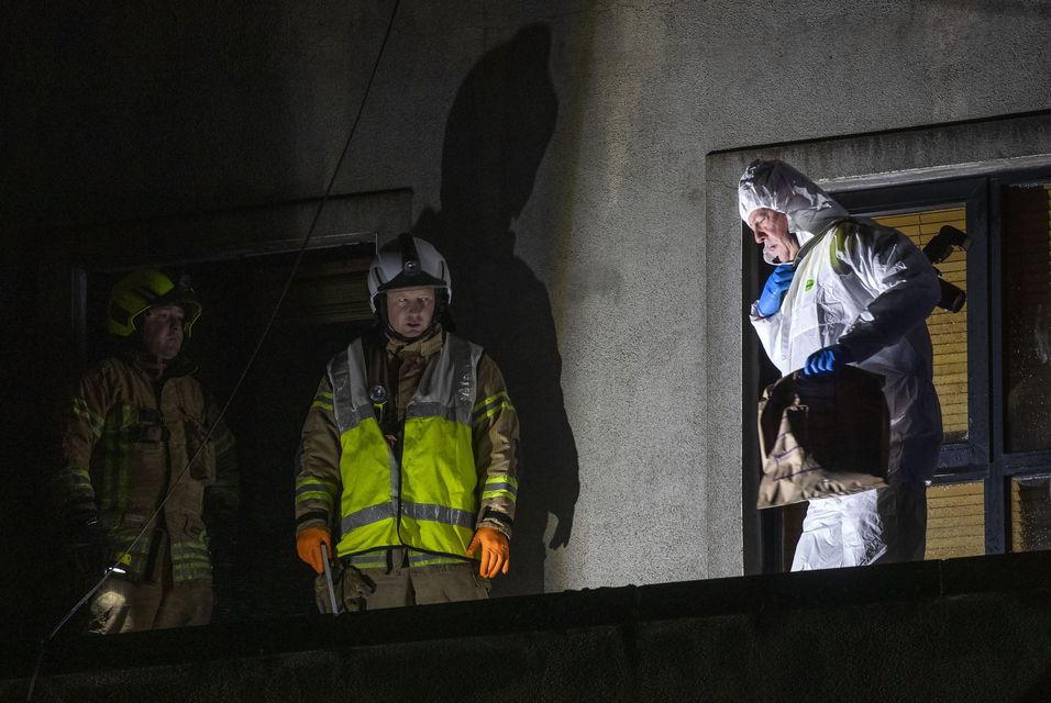 Gardaí and firefighters pictured on the balcony of an apartment at the scene of a fatal incident on School Street, Kilcock, County Kildare. Picture: Colin Keegan, Collins Dublin