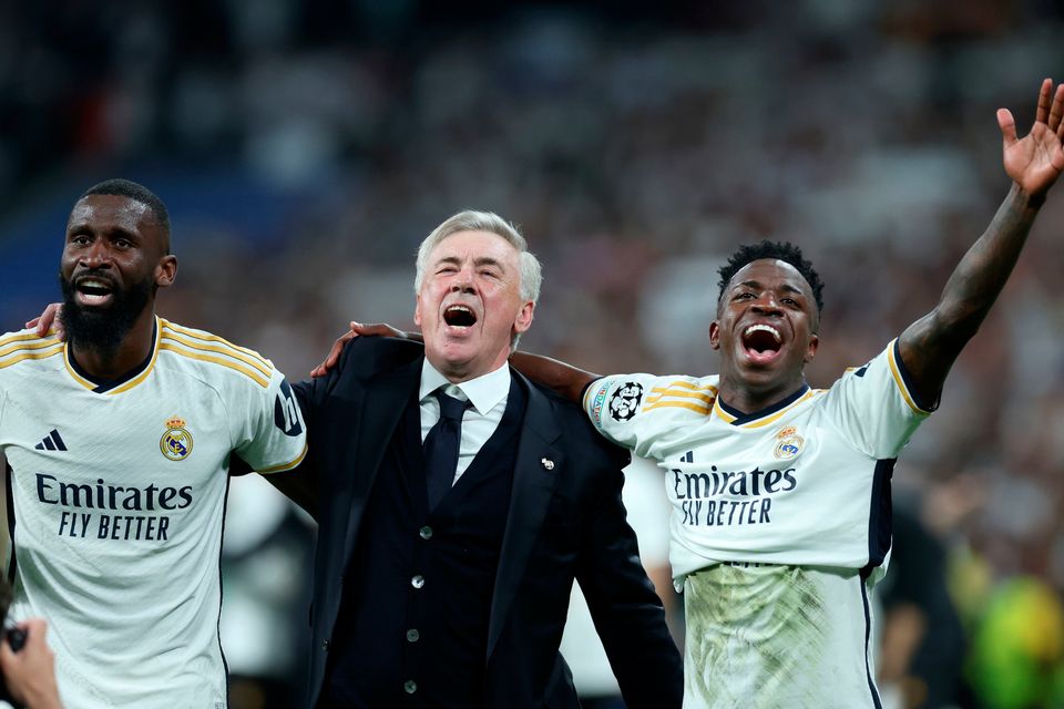 Carlo Ancelotti celebrates with Antonio Rudiger (left) and Vinicius Junior after Real Madrid's Champions League semi-final victory.