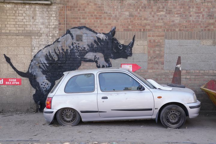 Banksy’s rhino artwork defaced by man in balaclava hours after being unveiled