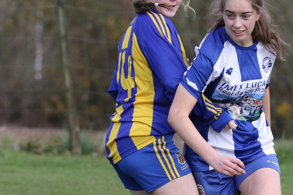 Lisa Nangle of St. Joseph's tries to slow the progress of Aoife Connolly of Aughrim Rangers.