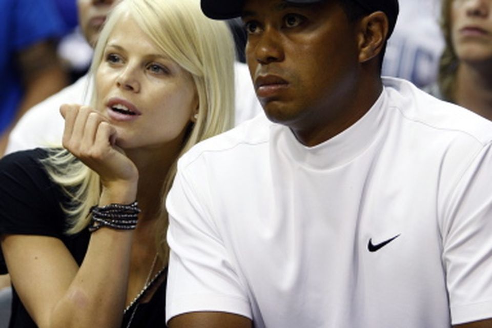 Golfer Tiger Woods and his wife Elin sit courtside during Game 4 of their NBA Finals basketball game in Orlando...Golfer Tiger Woods and his wife Elin sit courtside during Game 4 of their NBA Finals basketball game between the Orlando Magic and the Los Angeles Lakers in Orlando, Florida  June 11, 2009.     REUTERS/Hans Deryk (UNITED STATES SPORT BASKETBALL)...S