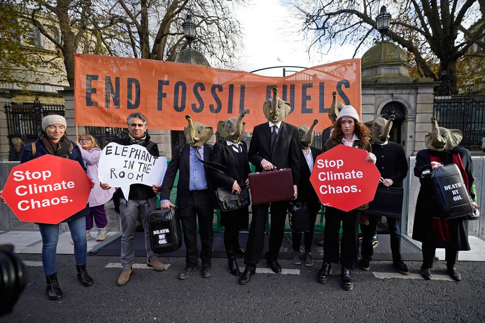 Stop Climate Chaos members, dressed in black business suits and wearing elephant masks, outside Leinster House in Dublin ahead of Cop28. Photo: PA