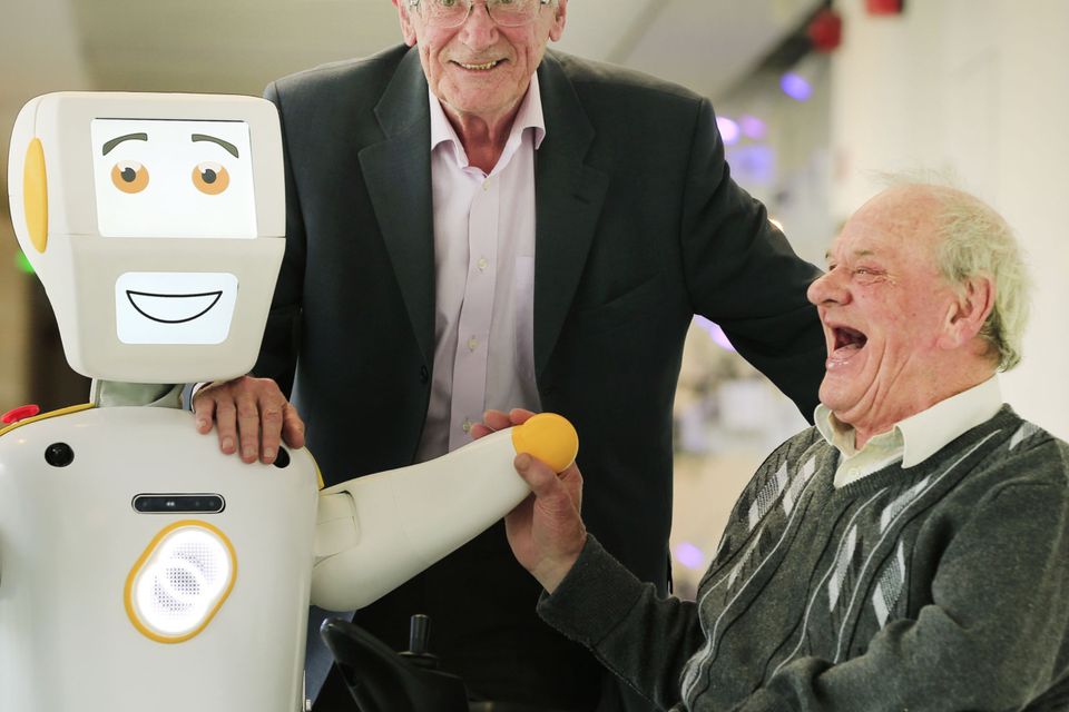 ‘A bit of banter’: Tony McCarthy and Brendan Crean in Trinity College Science Gallery with Stevie II, Ireland’s first socially assistive AI robot. 
Picture by Gerry Mooney