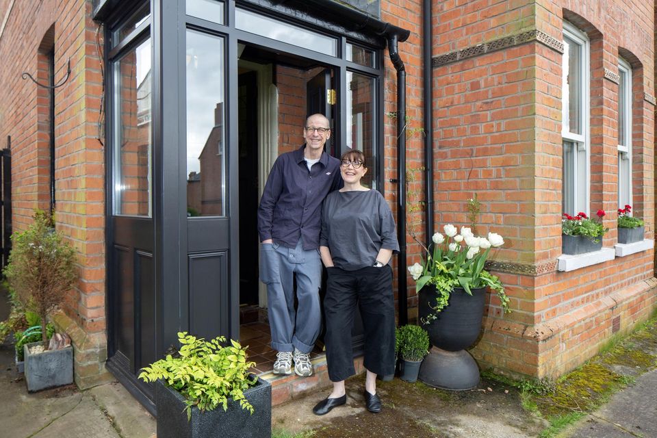Artist/musician  Garret Faulkner and arts consultant Esther Haller-Clarke  outside their Victorian redbrick in Belfast, which dates from 1886. The houses were built for shipyard staff and one of the houses on the street bears a plaque dedicated to an engineer who went down on the Titanic. When they first saw the house the couple were particularly enchanted by a 100-year-old lime tree in the garden, as getting closer to nature was top of their list of must-haves. Photo: Tony Gavin